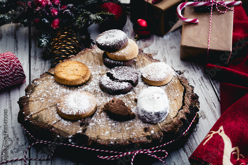 Traditional Spanish Christmas candy. Andalusian Shortbread cookies (Polvorones) on on oak tree trunk photo