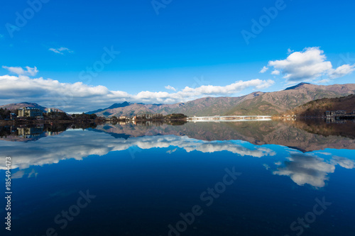 landscape river reflection view of bridge, mountain and traffic under blue sky, nature background