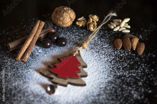 Christmas Decoration and walnuts, almonds, pine nuts, cinnamon, chocolate