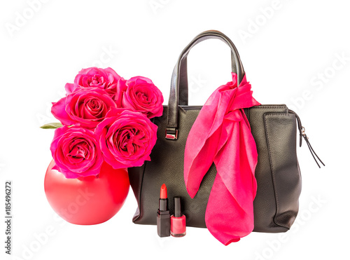 Black bag, lipstick, nail polish and roses in vase isolated on white background