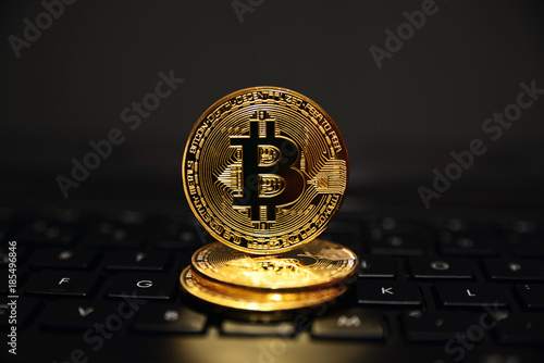 Coin bitcoin on the keyboard, the concept of wealth, crypto currency