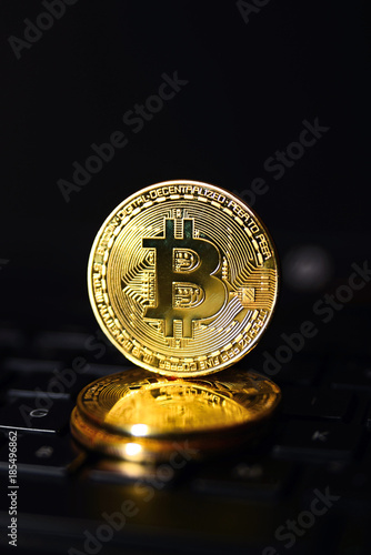 Coin bitcoin on the keyboard, the concept of wealth, crypto currency