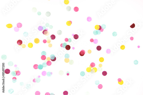 Multicolored confetti on white photo