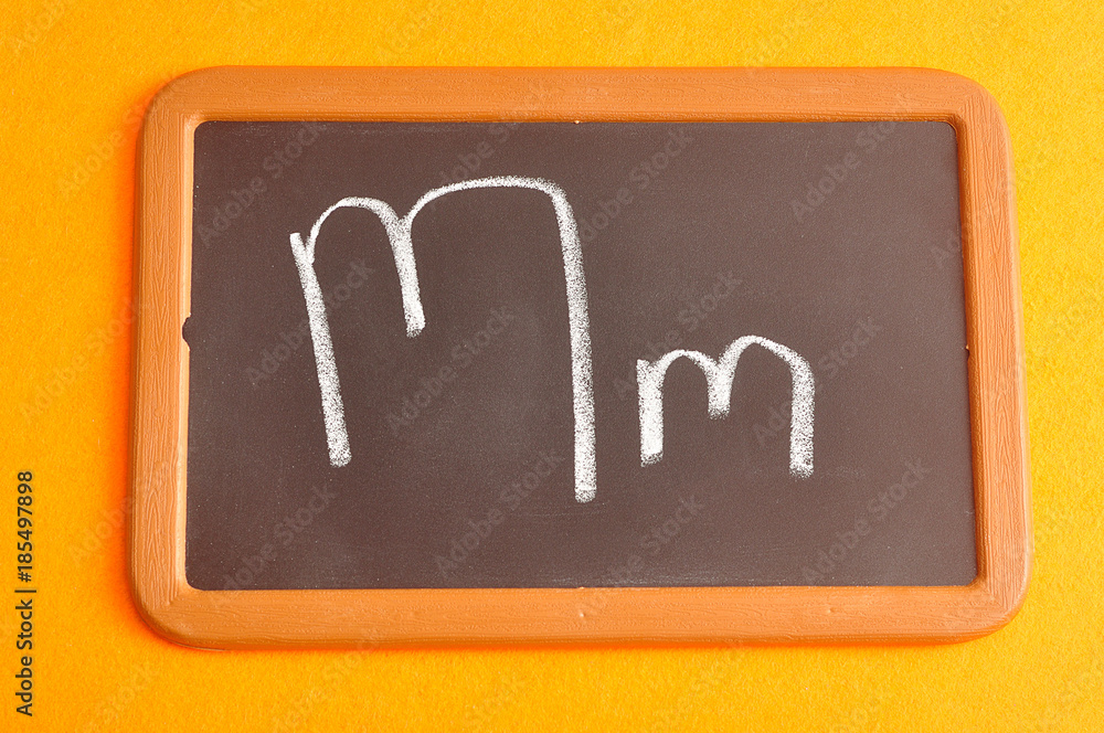 A black board with the alphabet letter M in a capital and small letter A black board with the alphabet letter M in a capital and small letter