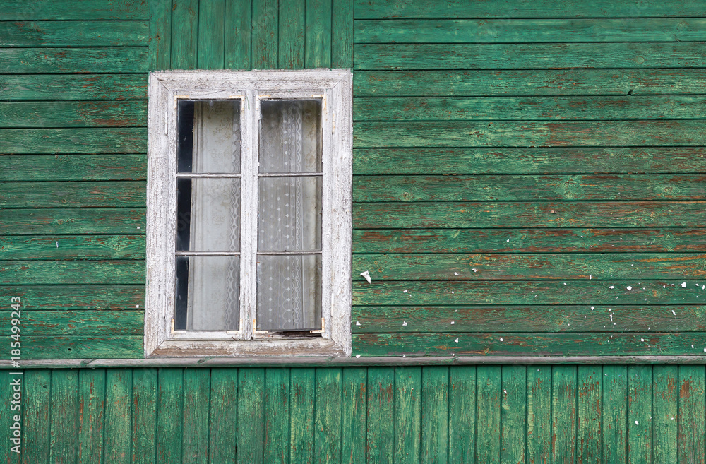 The old window of old wooden house. Background of wooden walls