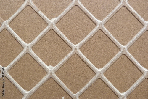 brown ceramic tile with white rhombuses cardboard close-up background for design background backdrop glazed gingerbread texture abstraction geometric pattern