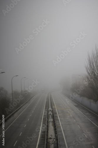 an abandoned empty road with fog