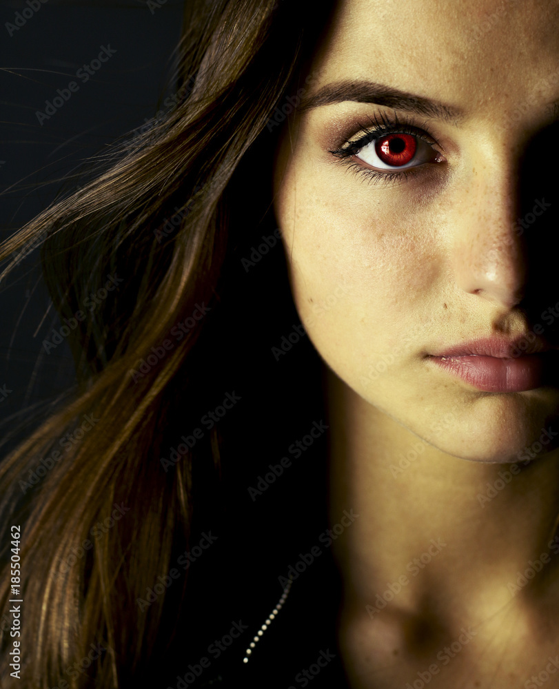Portrait of beautiful vampire young woman with red eyes. Stock ...