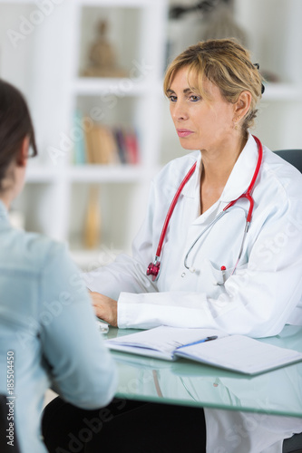 Wallpaper Mural smiling female doctor showing digital tablet to patient Torontodigital.ca