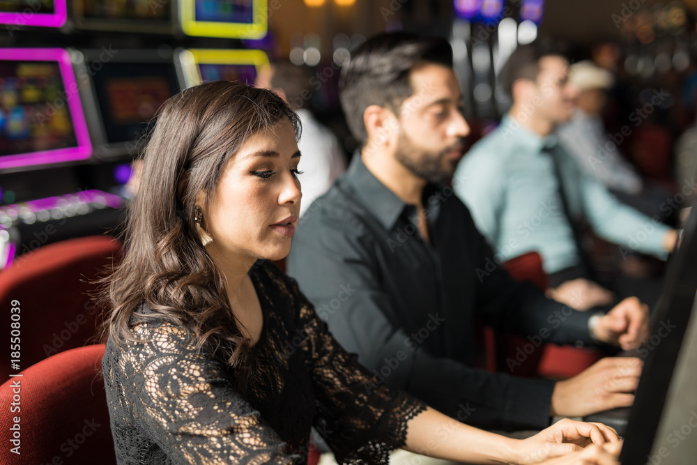 Woman playing in a slot machine Woman playing in a slot machine