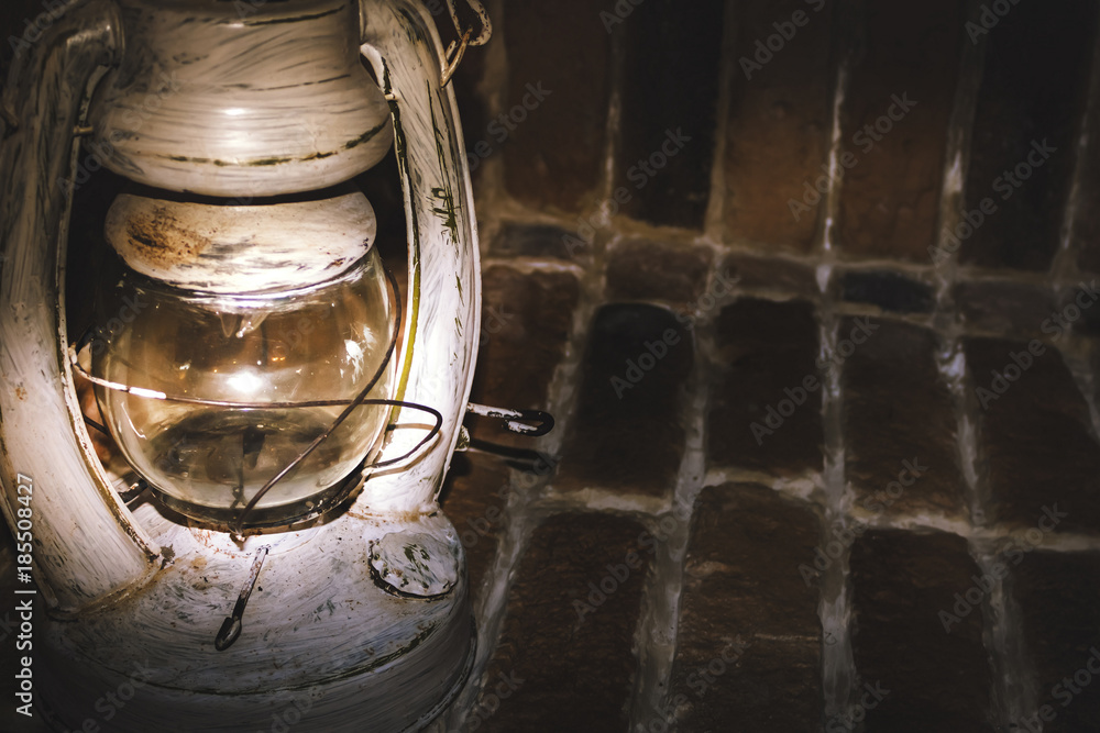 vintage kerosene lamp standing on the stone floor