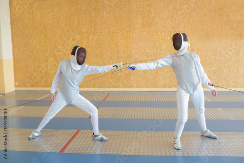 Two people in fencing combat