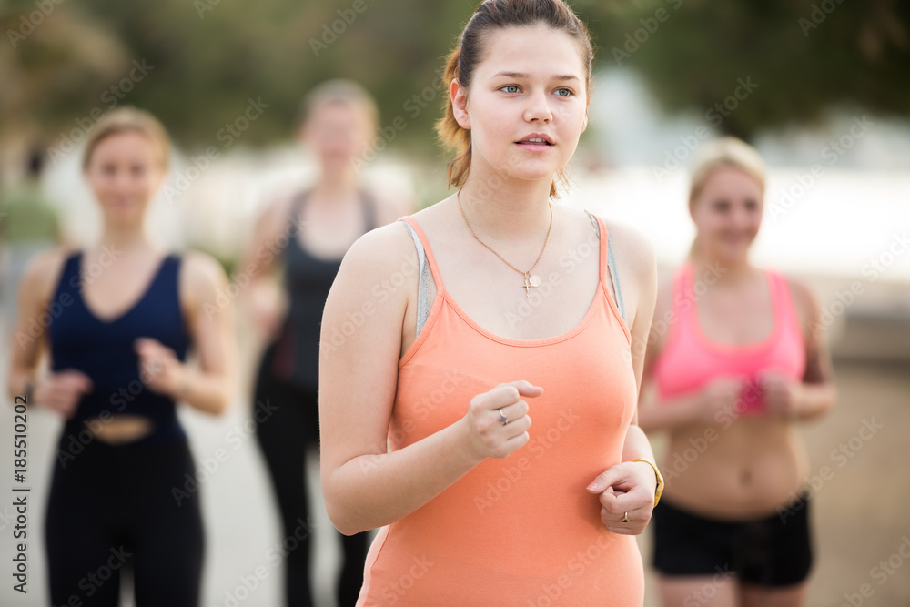 Fototapeta premium Cheerful young women during racewalking training