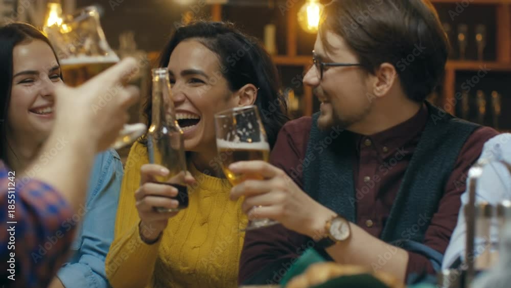 Company of Friends Having Fun in the Bar, They Drink, Talk and Joke Around. Beautiful Young People Have Good Time. Shot on RED EPIC-W 8K Helium Cinema Camera. Company of Friends Having Fun in the Bar, They Drink, Talk and Joke Around. Beautiful Young People Have Good Time. Shot on RED EPIC-W 8K Helium Cinema Camera.