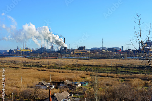 Smoke from the industrial plant over the city in the clouds. Factory smoke tubes. Polluted air photo