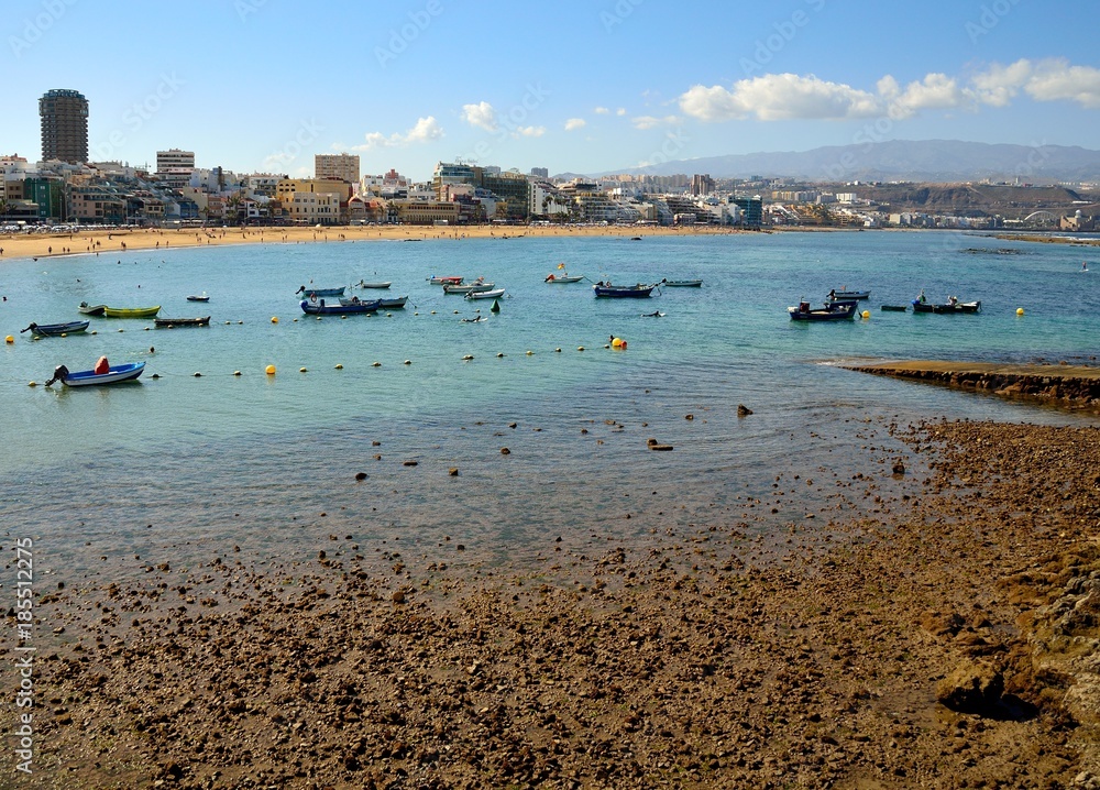 Las Canteras beach at low tide, fishing boats and city, Las Palmas, Canary islands
