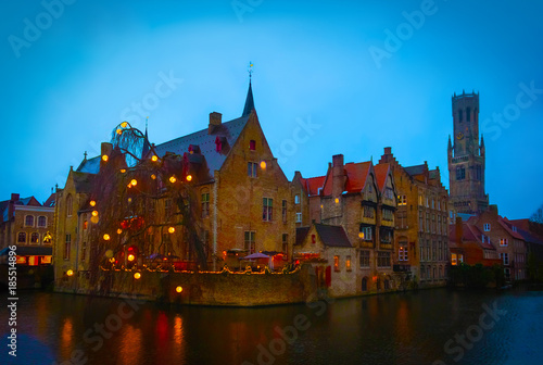 The evening shot of historic medieval buildings along a canal in Bruges, Belgium