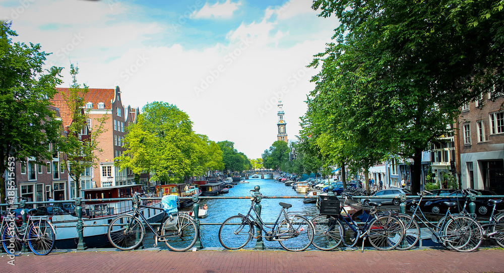 Channels and vintage bicycles on Amsterdam street. The capital of the Netherlands on a sunny summer day.