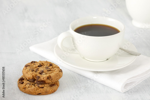Cup of coffee and cookies on the table.