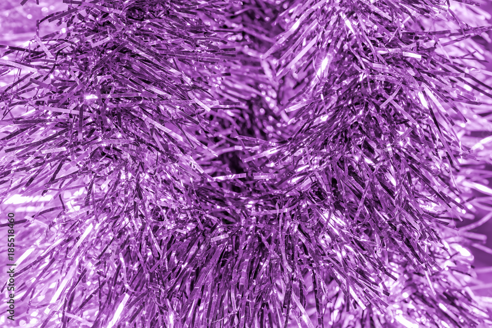 Fototapeta premium New year lilac background of tinsel, close-up