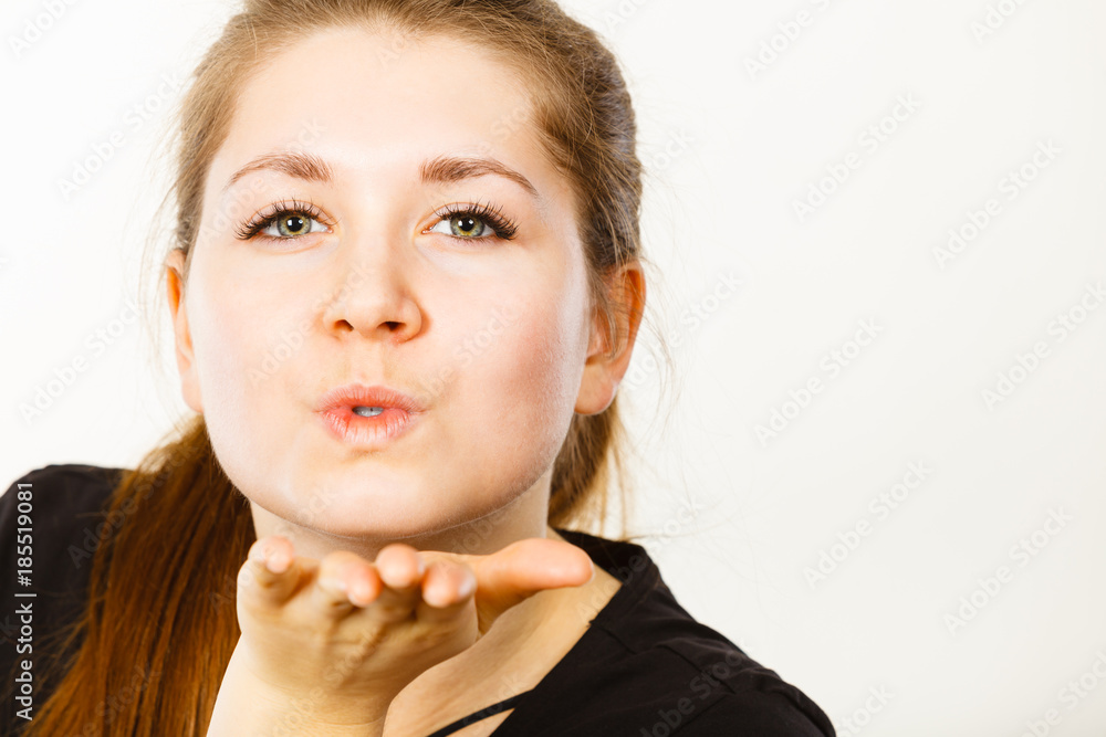 Portrait of happy attractive woman sending air kiss Portrait of happy attractive woman sending air kiss