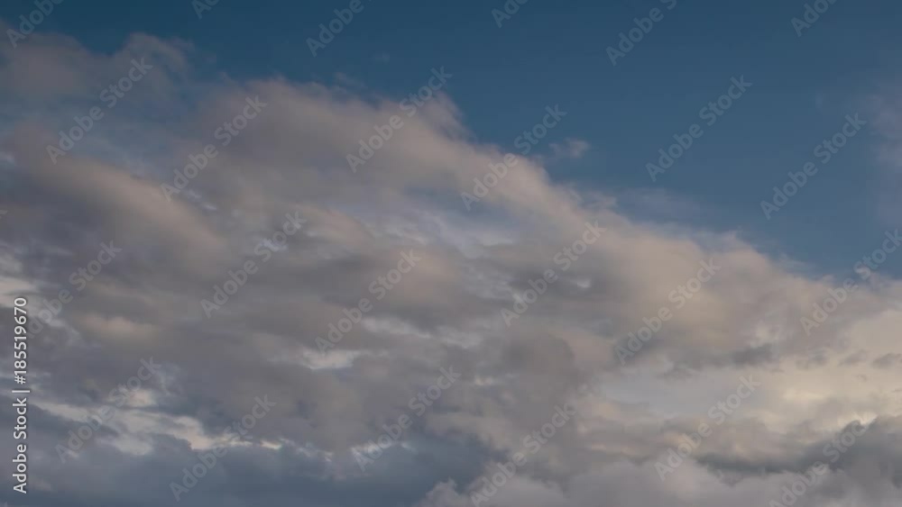 Russia, time lapse. Formation and rapid movement of white clouds of different shapes in the blue sky in late spring at sunset. Russia, time lapse. Formation and rapid movement of white clouds of different shapes in the blue sky in late spring at sunset.