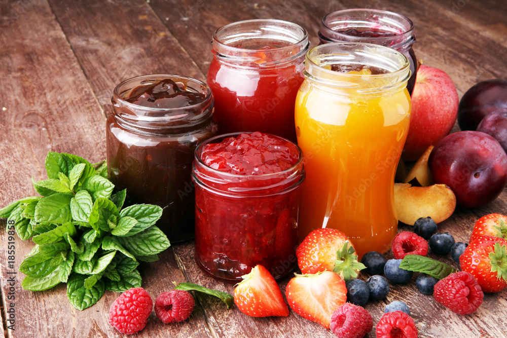 assortment of jams, seasonal berries, plums, mint and fruits assortment of jams, seasonal berries, plums, mint and fruits