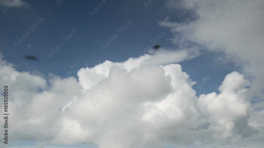 Russia, time lapse. Formation and rapid movement of white clouds of different shapes in the blue sky in late spring at sunset. Russia, time lapse. Formation and rapid movement of white clouds of different shapes in the blue sky in late spring at sunset.