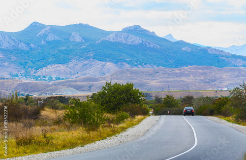 landscape with mountains, road and car © Yuri Bizgaimer