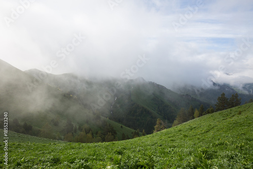 The formation and movement of clouds over the summer slopes of Adygea Bolshoy Thach and the Caucasus Mountains