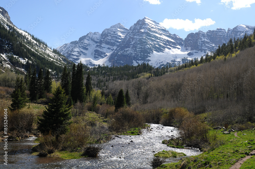 Maroon Creek - Spring time, Maroon Creek, filled with melt-water, rushing down from the side of famous Maroon Bells mountains, part of Elk Mountain, Aspen, Colorado, USA. Maroon Creek - Spring time, Maroon Creek, filled with melt-water, rushing down from the side of famous Maroon Bells mountains, part of Elk Mountain, Aspen, Colorado, USA.