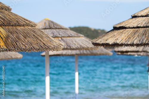 Fototapeta Naklejka Na Ścianę i Meble -  Straw umbrellas on the beach