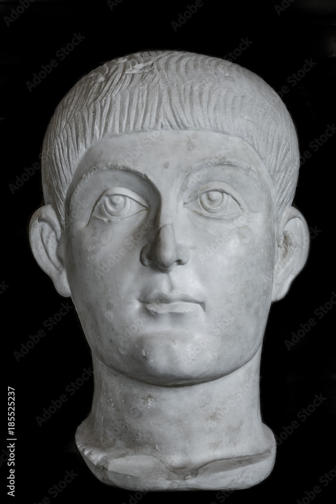 Statue of young Roman Noble boy at black background, Rome, Italy