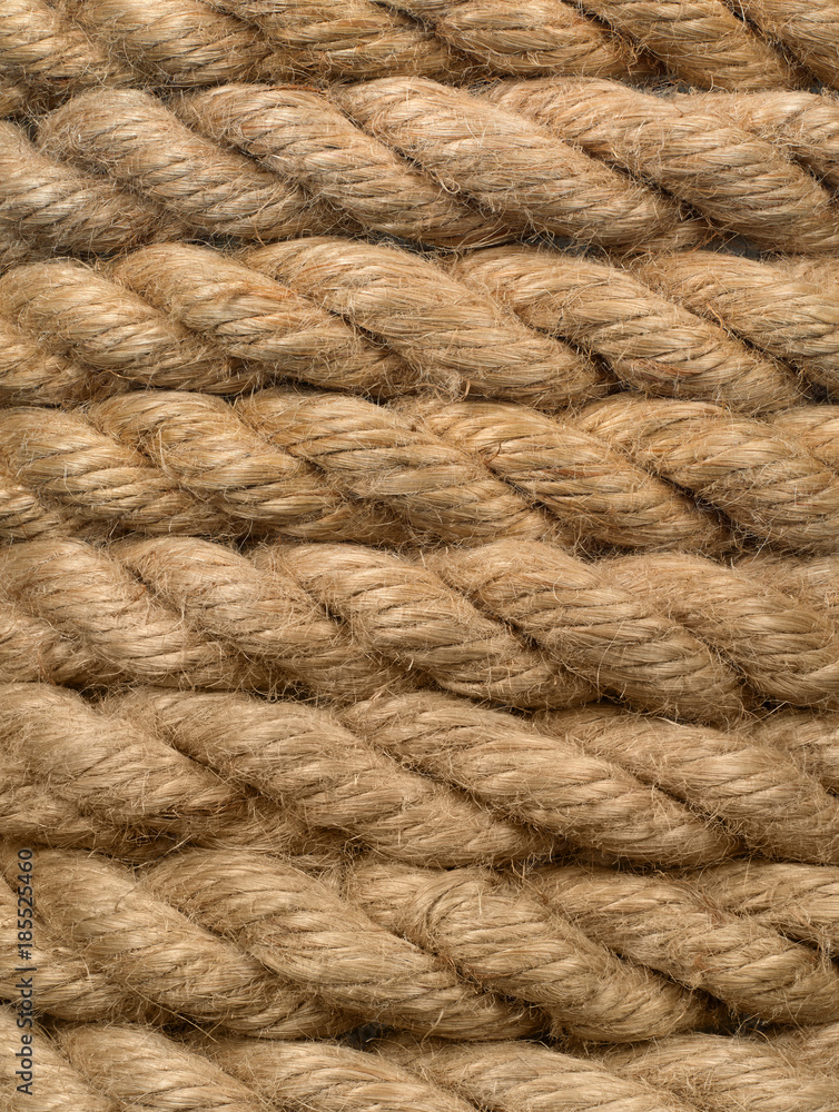 Vertical close-up of an old worn boat cable as background.