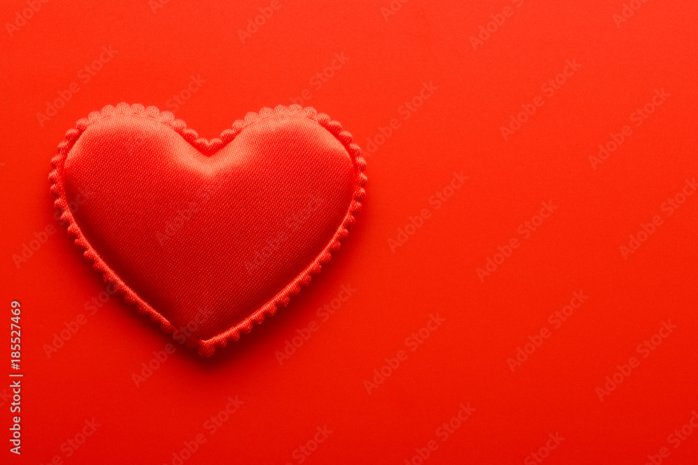 Small heart on red background