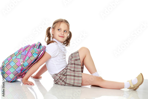 Quadro su tela Girl schoolgirl sitting on the floor