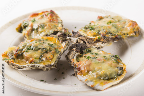 Canvas-taulu Four Oysters Rockefeller on a white plate