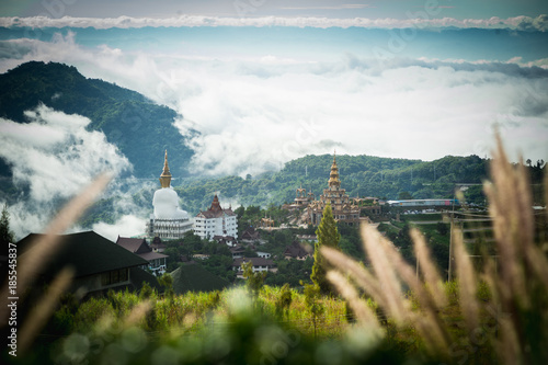 Big Buddha statue and pagoda on top of a hill with great views of the surrounding mountainous area at Wat Pha Sorn Kaew Temple in Khao Kho, Phetchabun Province, Thailand.