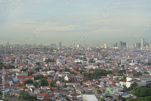 Cityscape of Jakarta city with buildings  houses  and busy road.