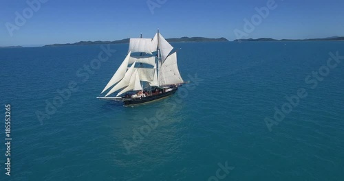 WHITSUNDAY ISLANDS – FEBRUARY 2016 : Aerial shot of sailboat / ship on a sunny day with amazing landscape and ocean in view photo