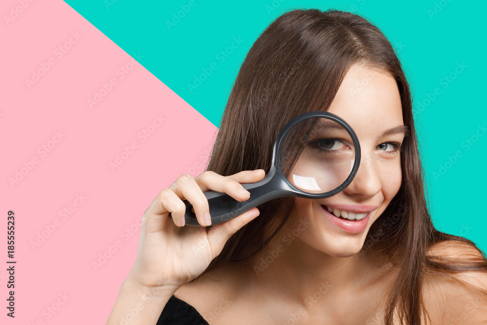 girl looking through a magnifying glass girl looking through a magnifying glass