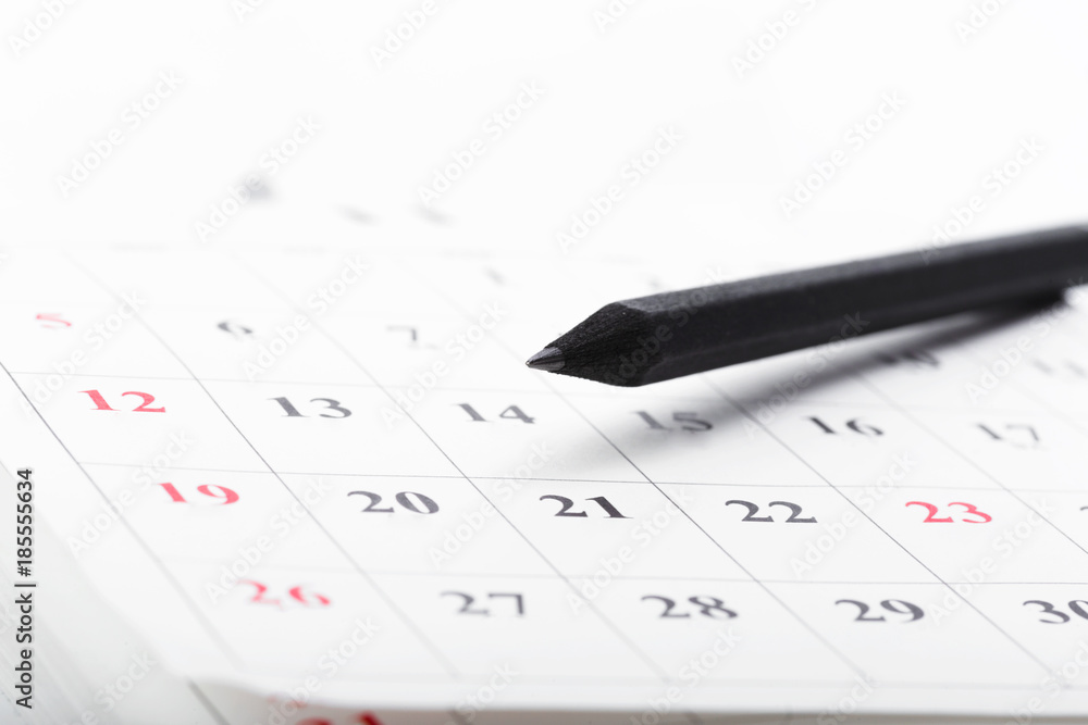 Check out the dates in a business calendar concept Check out the dates in a business calendar concept