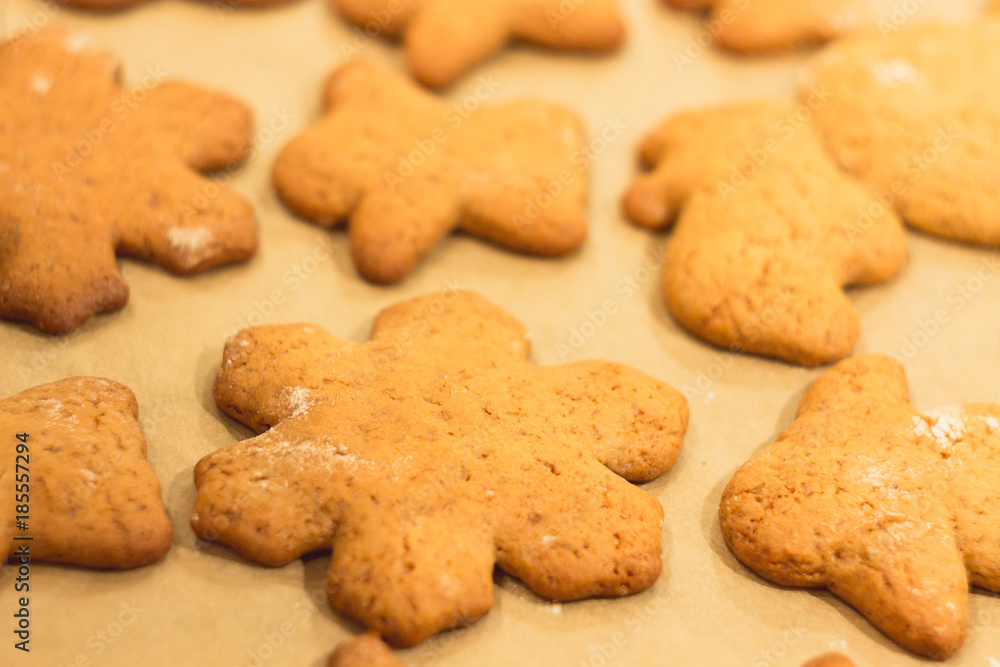 Ginger biscuits lie on a baking sheet. Cookies on baking paper. Selective focus. Ginger biscuits lie on a baking sheet. Cookies on baking paper. Selective focus.