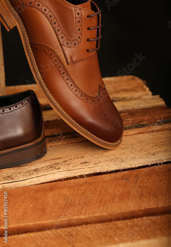 Brown Leather Shoes on Wooden Boxes