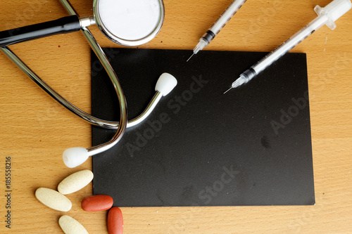 Healthcare concept with stethoscope,medicine and insulin syringe. Copy space photo