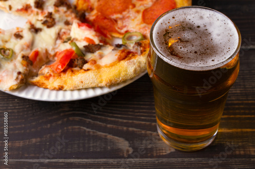Glass of beer and pizza. Ale and food