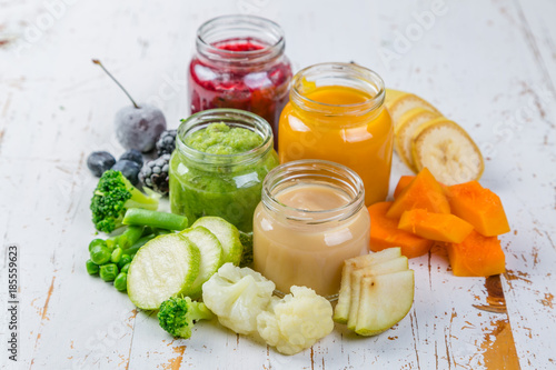 Colorful baby food purees in glass jars photo
