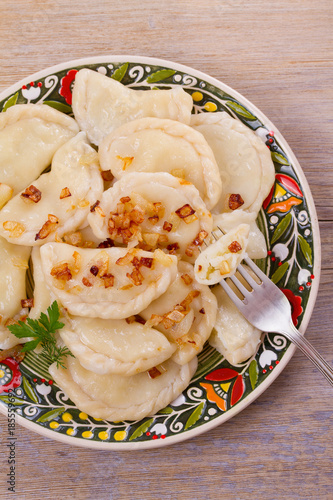 Dumplings, filled with potato and served with fried onion. Varenyky, vareniki, pierogi, pyrohy. overhead