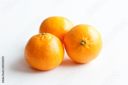 Mandarin isolated on white background. Three ripe tangerines lying around.