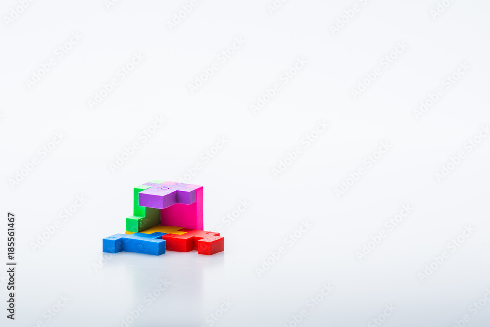 Colourful 3D puzzle piece isolated on white background. Concept of puzzle solving. Isolated on white background. Slightly de-focused and close-up shot. Copy space. Colourful 3D puzzle piece isolated on white background. Concept of puzzle solving. Isolated on white background. Slightly de-focused and close-up shot. Copy space.